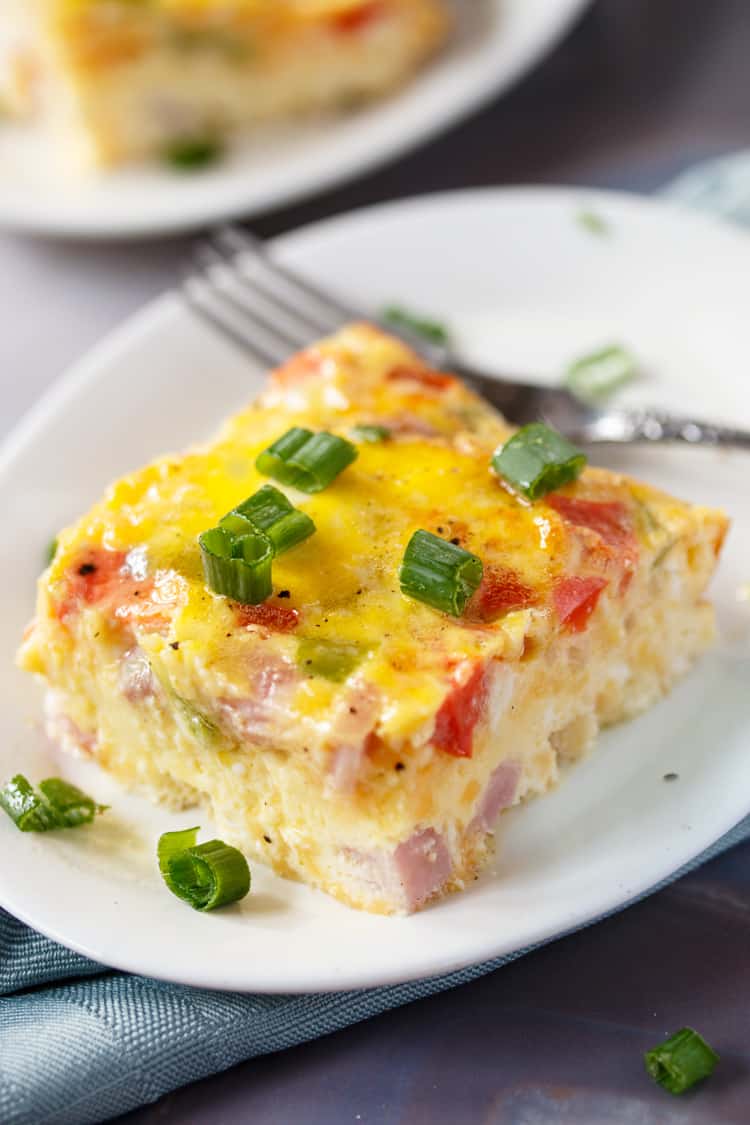 This Denver Omelette Egg Bake is loaded with ham, bell peppers, onions and cheese mixed with fluffy eggs and ready in 30 minutes from start to finish! denver-omelette-egg-bake