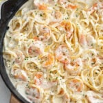 A skillet of Shrimp Alfredo with Fettucine pasta.