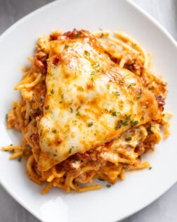 Overhead view of a slice of Spaghetti Pie on a white plate.